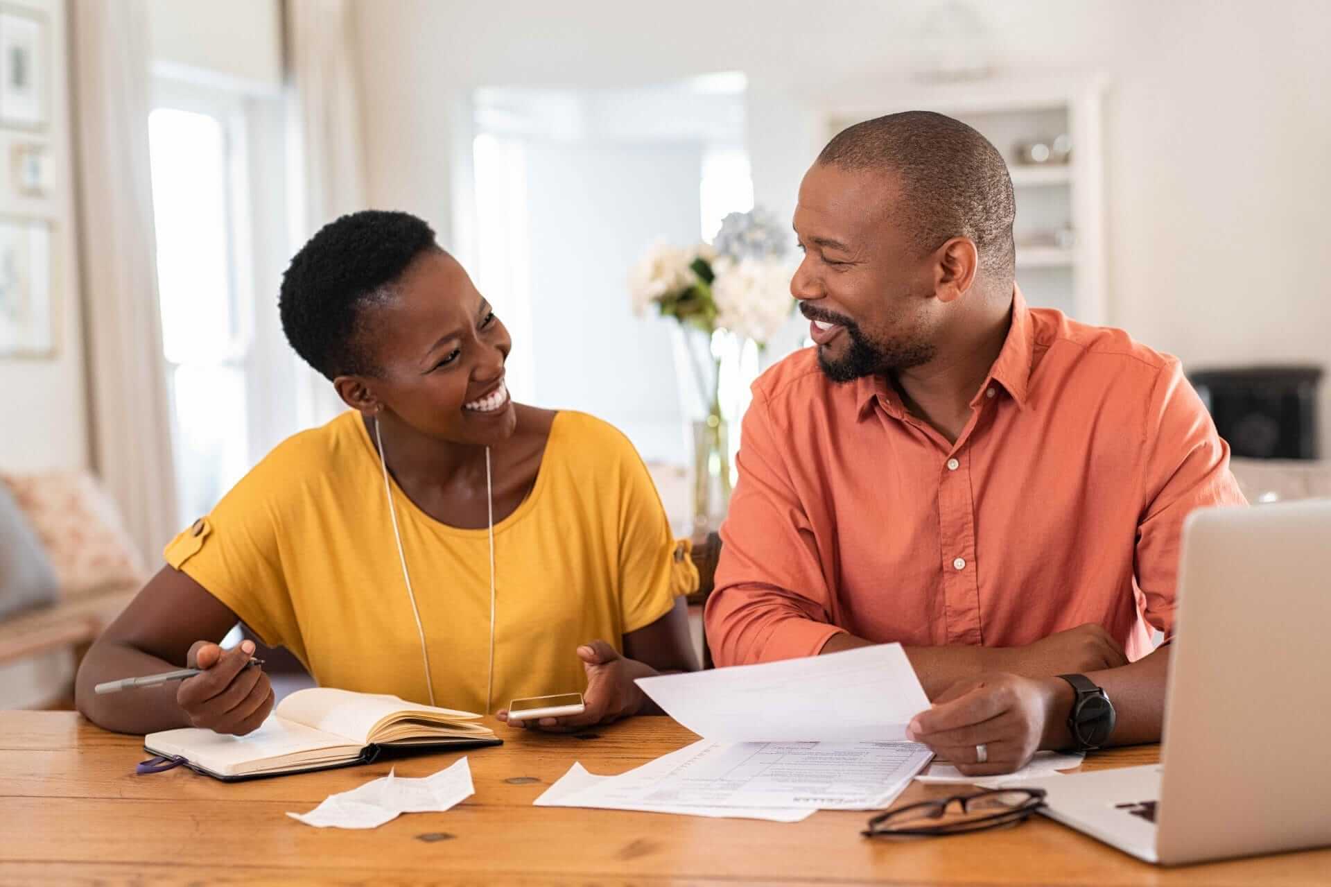 couple sitting in living room doing finances